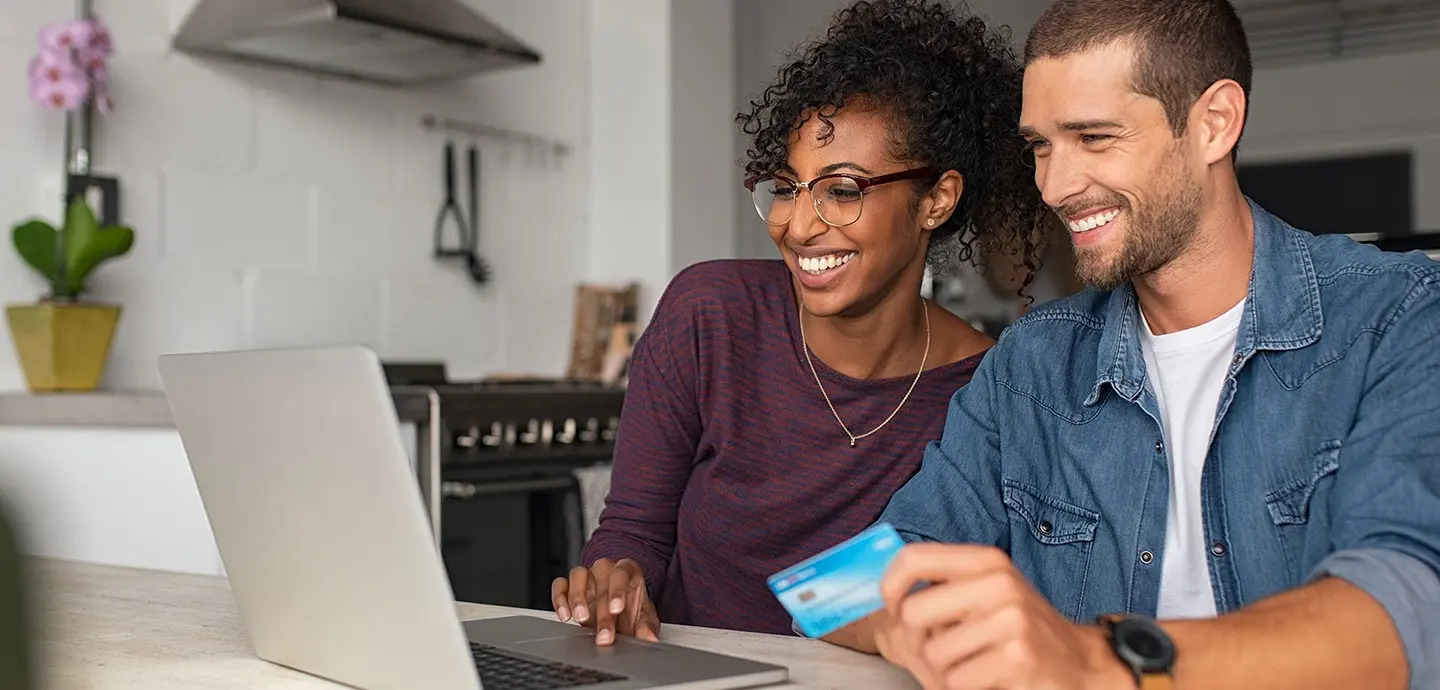 Man and Women with Credit card looking at computer